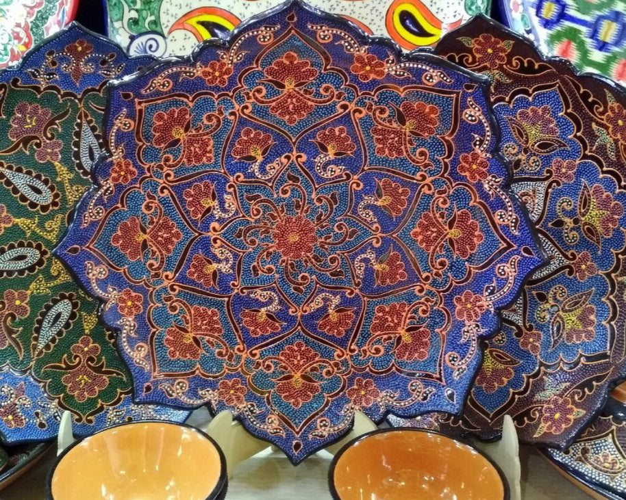 Decorative plates with intricate patterns on a market stall.