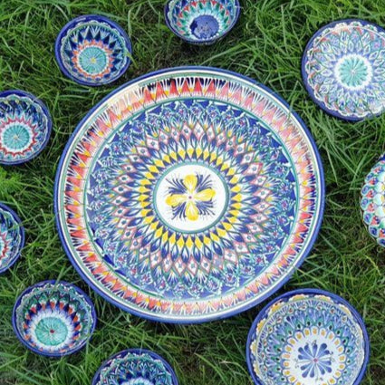 Colorful ceramic dish set on grass